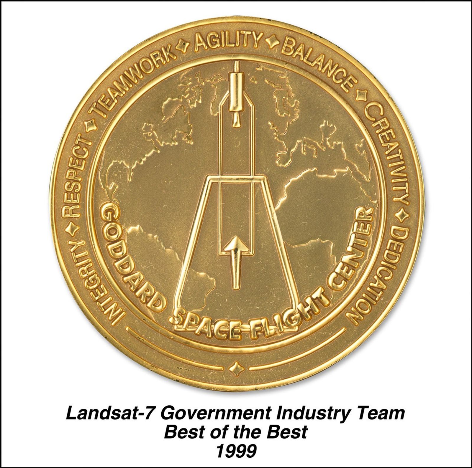 Gold commemorative medal for the Landsat-7 Government Industry Team. The circular medal features a stylized rocket or launch vehicle design in the center, positioned over an outline map of Earth's continents. Around the outer ring are the words 'RESPECT', 'TEAMWORK', 'AGILITY', 'BALANCE', 'CREATIVITY', 'DEDICATION', and 'INTEGRITY' separated by diamond symbols. The phrase 'GODDARD SPACE FLIGHT CENTER' spans the bottom portion. Below the medal is text reading 'Landsat-7 Government Industry Team Best of the Best 1999'.