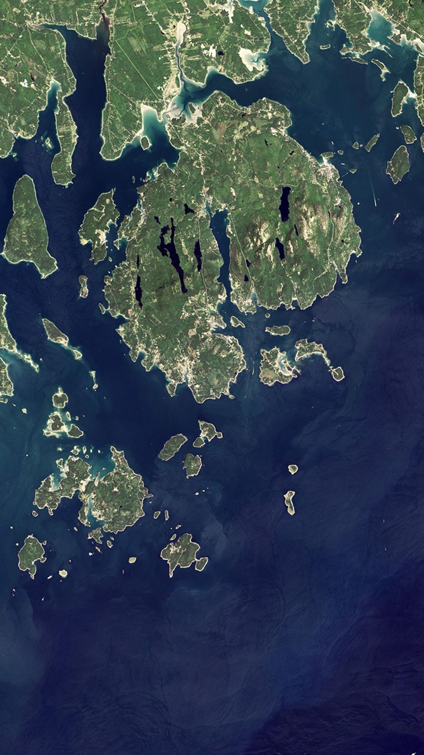 Natural-color Landsat 8 image of Acadia National Park in Maine acquired on September 6, 2015. In the image, vegetation appears green and water appears dark blue. Mountains and hills roll right up to the Atlantic Ocean in this rocky landscape.