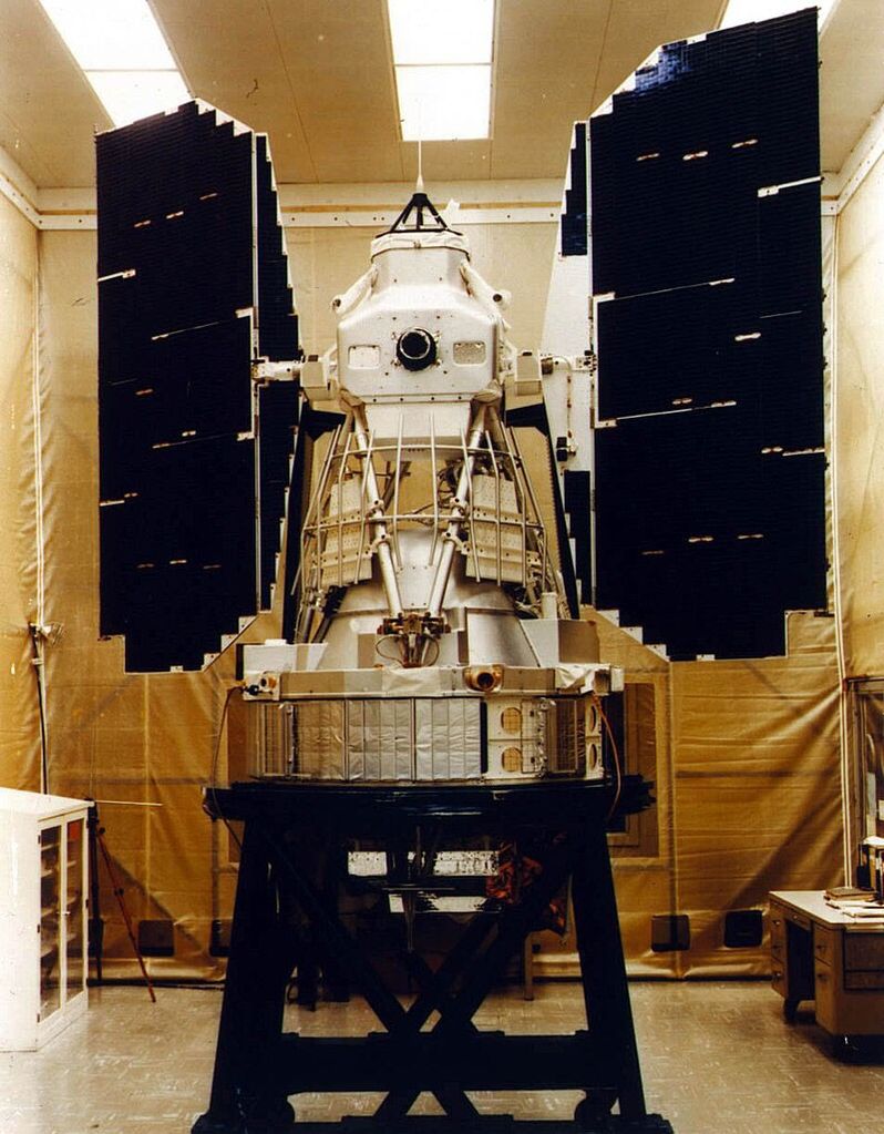 An image of Landsat 3 in a cleanroom undergoing pre-flight preparation.