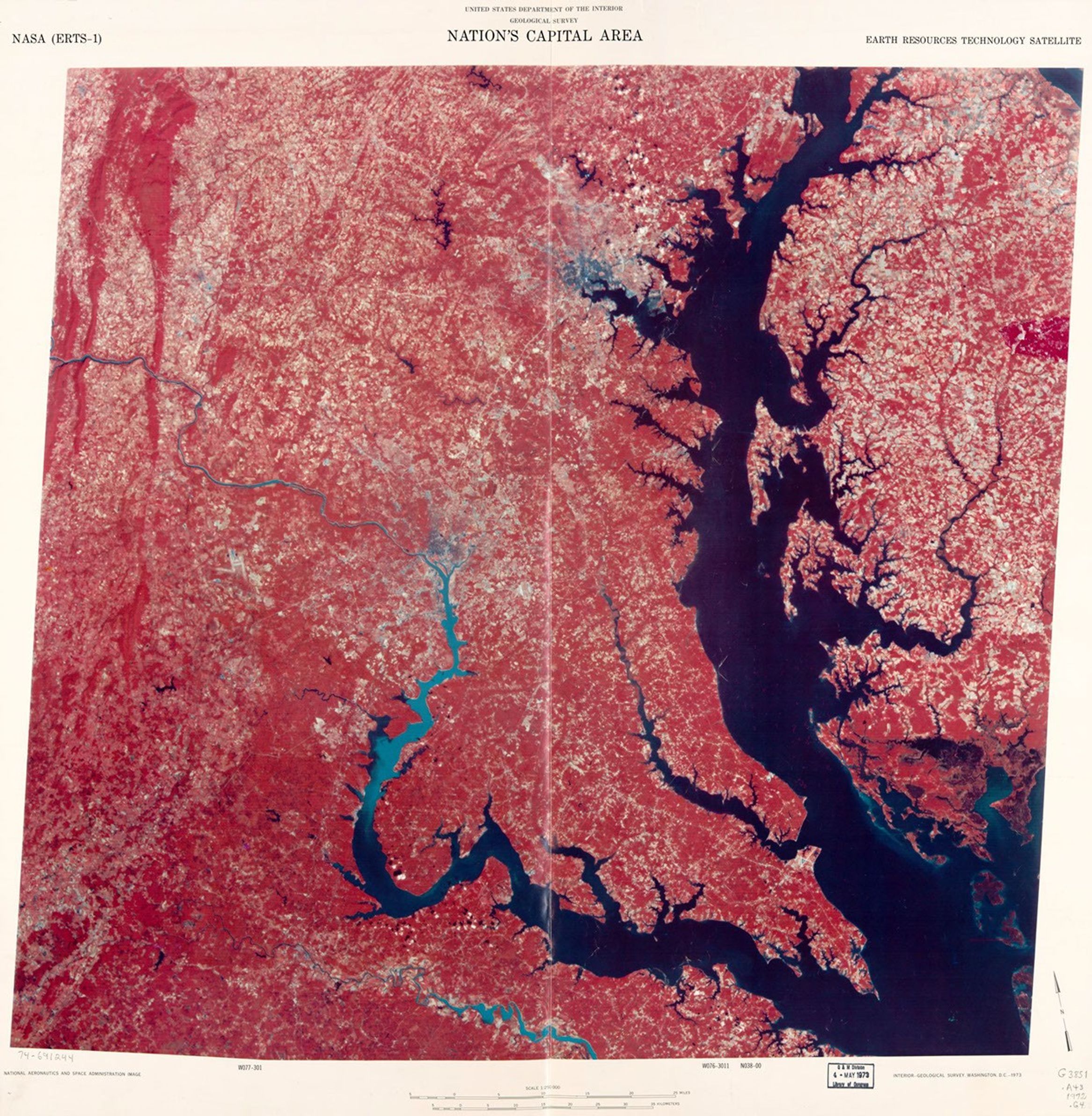A false-color satellite image map of the Washington D.C. and Chesapeake Bay region from 1972, created using ERTS-1 (Landsat 1) data. The image shows water bodies in dark blue, vegetation in red, and developed areas in lighter tones. The distinctive shape of the Chesapeake Bay is prominently visible on the right side, with the Potomac River flowing toward Washington D.C. in the center-left portion of the image.