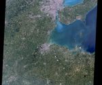 Landsat 4's first light image captured eastern Lake Erie, and the cities of Toledo, Detroit, and Windsor on July 25, 1982.