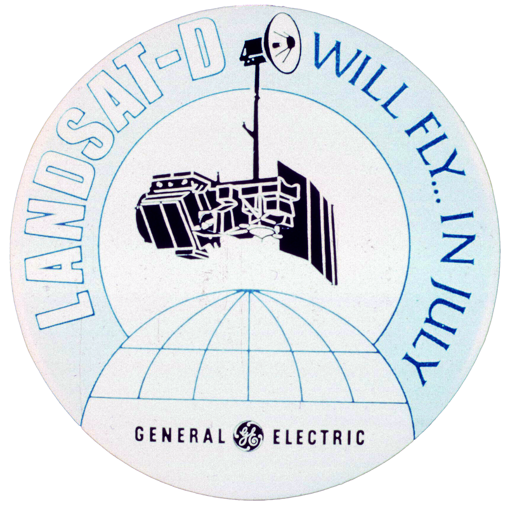 A Landsat-D mission patch with the text "Landsat-D Will Fly... In July" and "General Electric" written below.