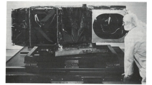 A photograph of the Protoflight Thematic Mapper on shipping container base, aperture view.