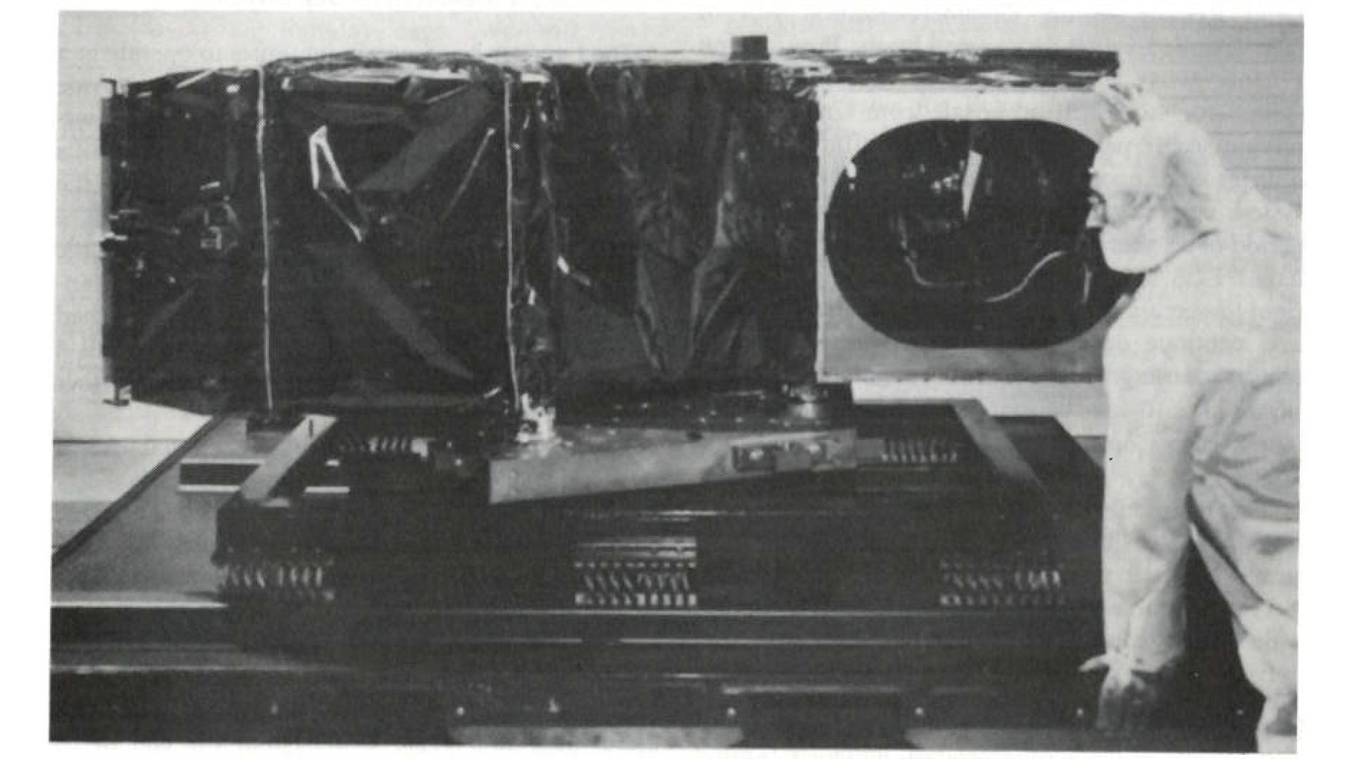 A photograph of the Protoflight Thematic Mapper on shipping container base, aperture view.
