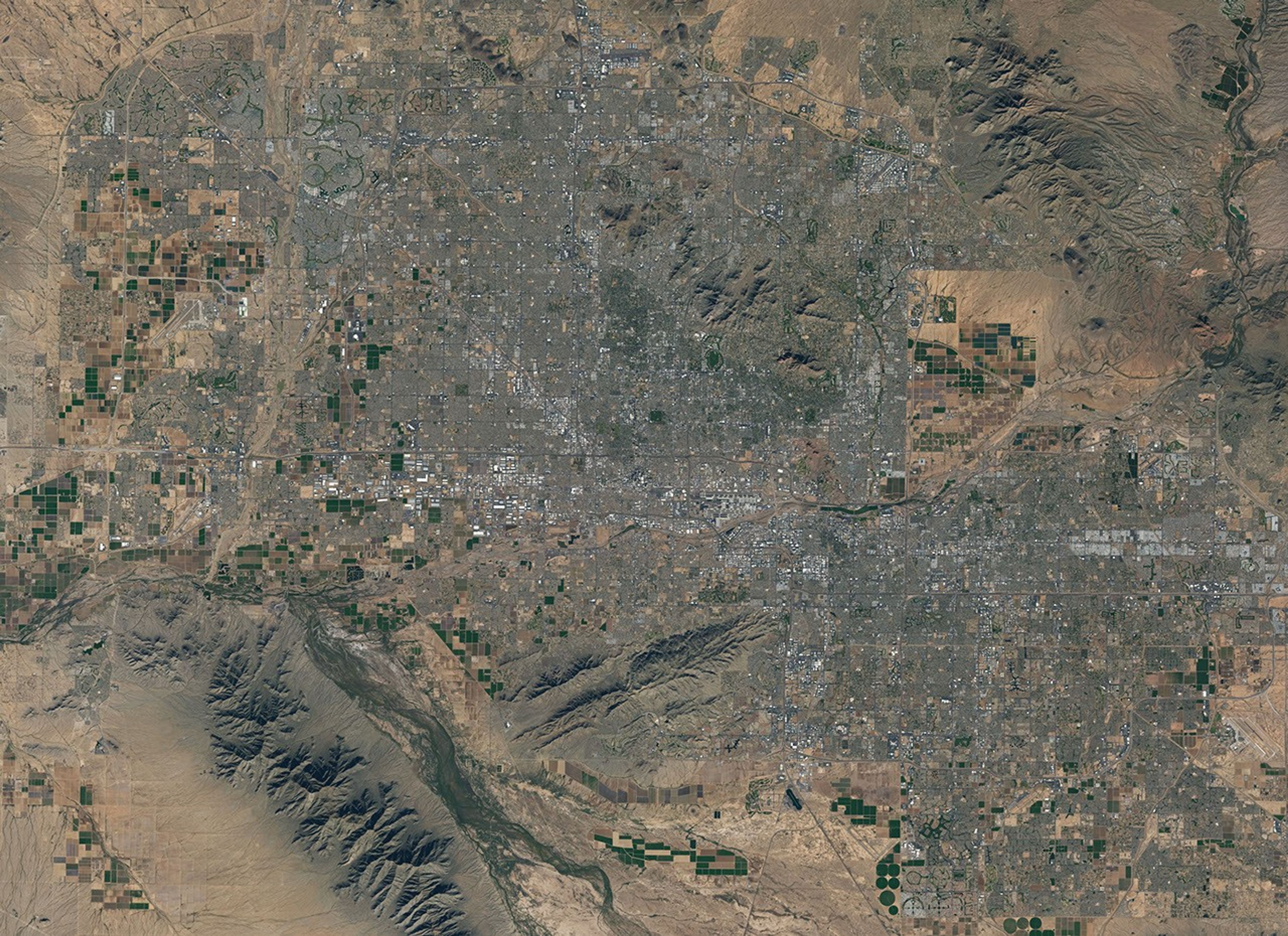 Landsat 7 image of Phoenix, Arizona acquired November 28, 2014.  Landsat 7 is a U.S. satellite used to acquire remotely sensed images of the Earth's land surface and surrounding coastal regions. It is maintained by the Landsat 7 Project Science Office at the NASA Goddard Space Flight Center in Greenbelt, MD.  Landsat satellites have been acquiring images of the Earth’s land surface since 1972. Currently there are more than 2 million Landsat images in the National Satellite Land Remote Sensing Data Archive.
