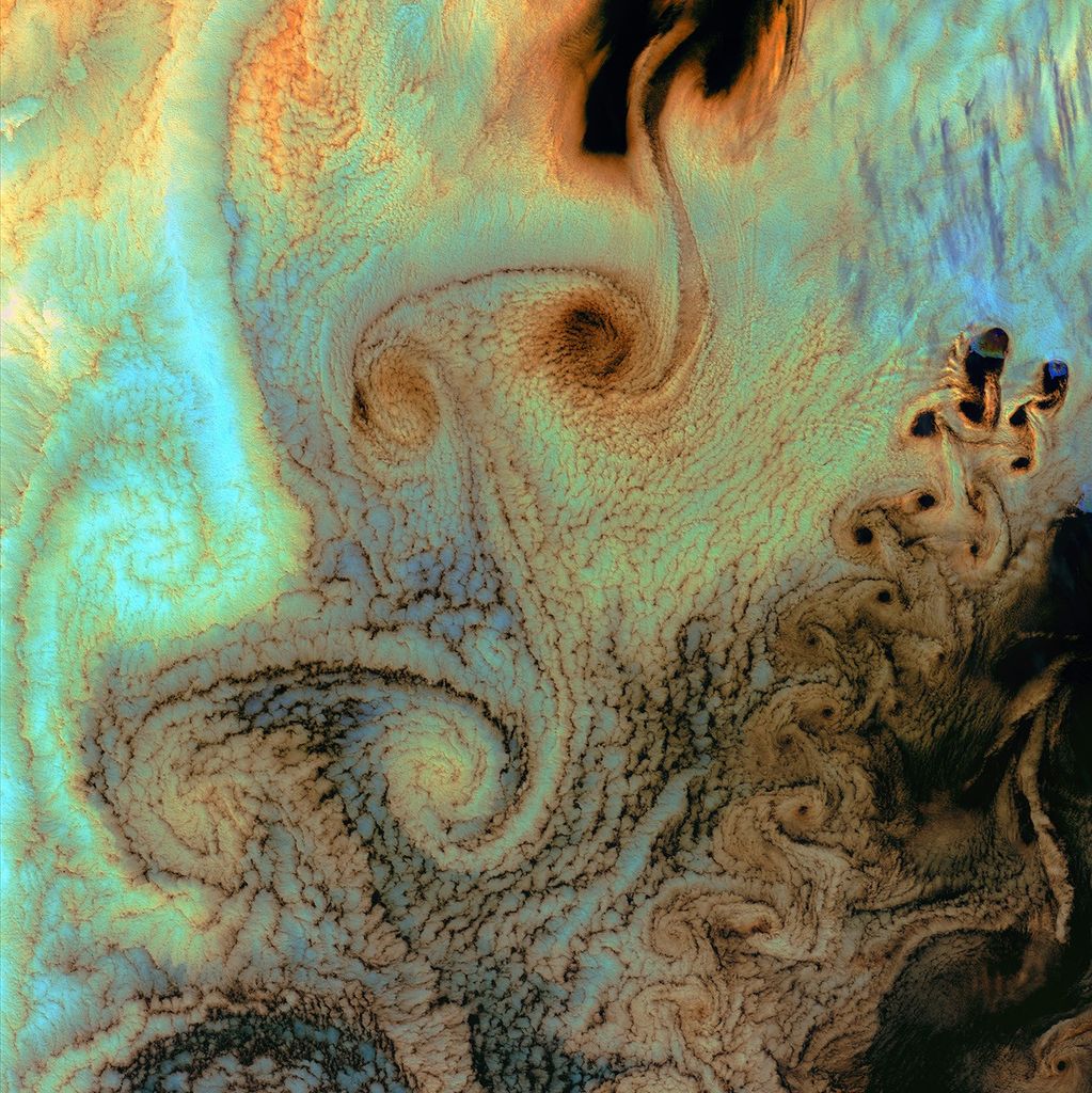 July 4th, 2002: Description: As air flows over and around objects in its path, spiraling eddies, known as Von Karman vortices, may form. The vortices in this image were created when prevailing winds sweeping east across the northern Pacific Ocean encountered Alaska’s Aleutian Islands.