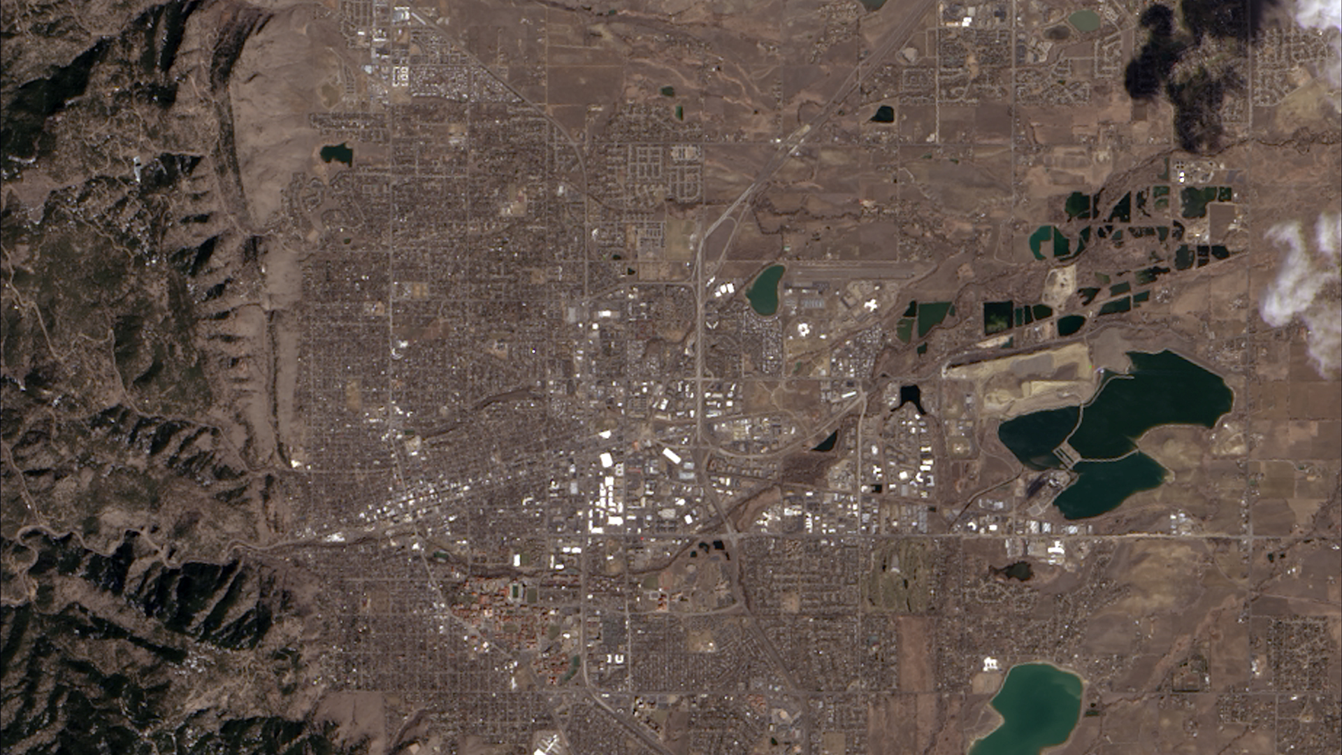 Landsat 8’s first light satellite image, acquired on March 18, 2013, shows Boulder, Colorado surrounded by tree-covered mountains and dormant plains.