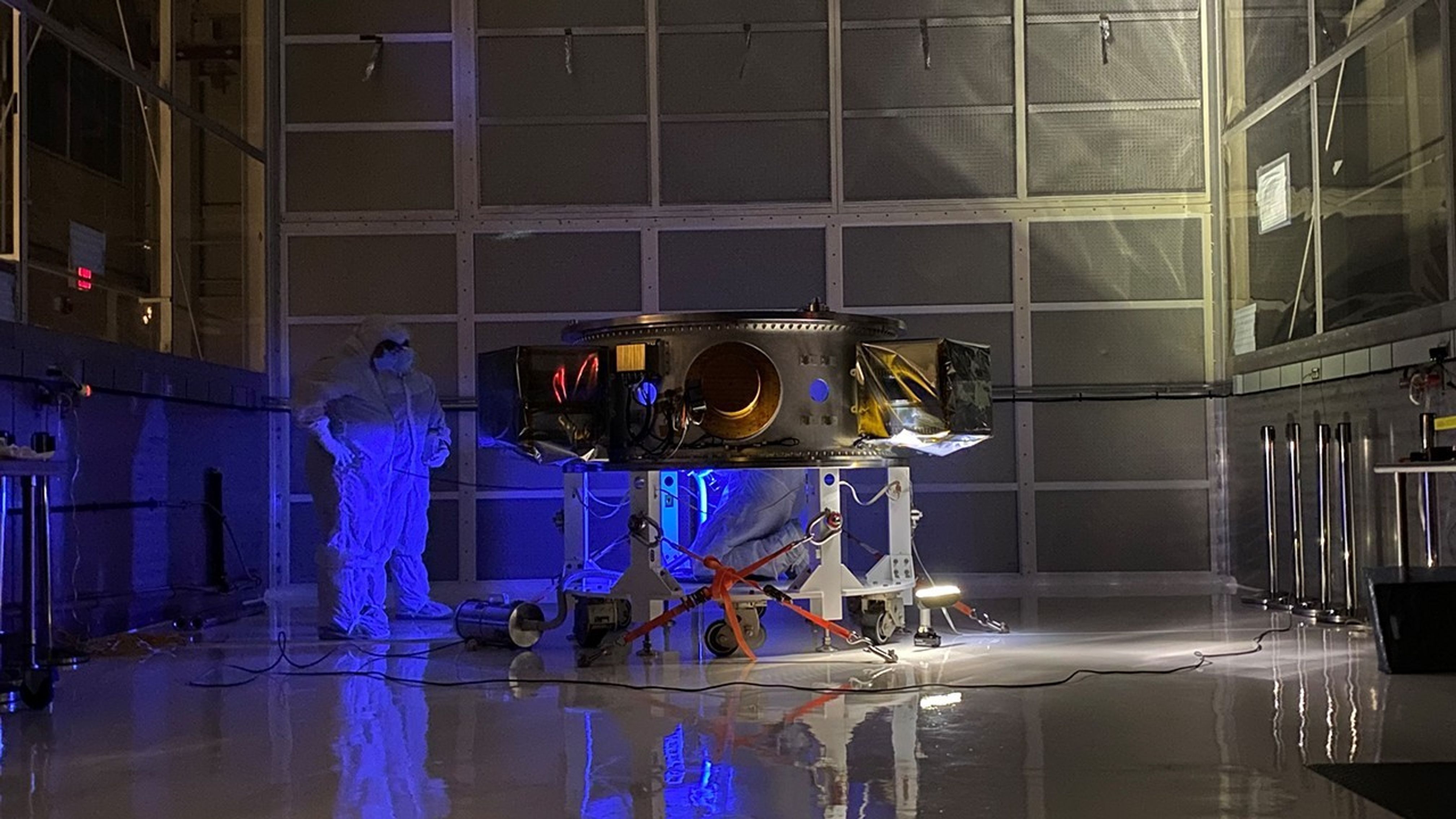 Technicians perform a blacklight inspection of the secondary payload adapter for NASA’s Landsat 9 mission at Vandenberg Space Force Base in California, on Aug. 4, 2021, before it is transported to the Integrated Processing Facility. Several secondary payloads, called CubeSats, will launch with Landsat 9 atop a United Launch Alliance Atlas V rocket from Vandenberg in September 2021. The launch is being managed by NASA’s Launch Services Program based at Kennedy Space Center, America’s multi-user spaceport. The Landsat 9 satellite will continue the nearly 50-year legacy of previous Landsat missions. It will monitor key natural and economic resources from orbit. Landsat 9 is managed by the agency’s Goddard Space Flight Center in Greenbelt, Maryland. The satellite will carry two instruments: the Operational Land Imager 2, which collects images of Earth’s landscapes in visible, near infrared and shortwave infrared light, and the Thermal Infrared Sensor 2, which measures the temperature of land surfaces. Like its predecessors, Landsat 9 is a joint mission between NASA and the U.S. Geological Survey.