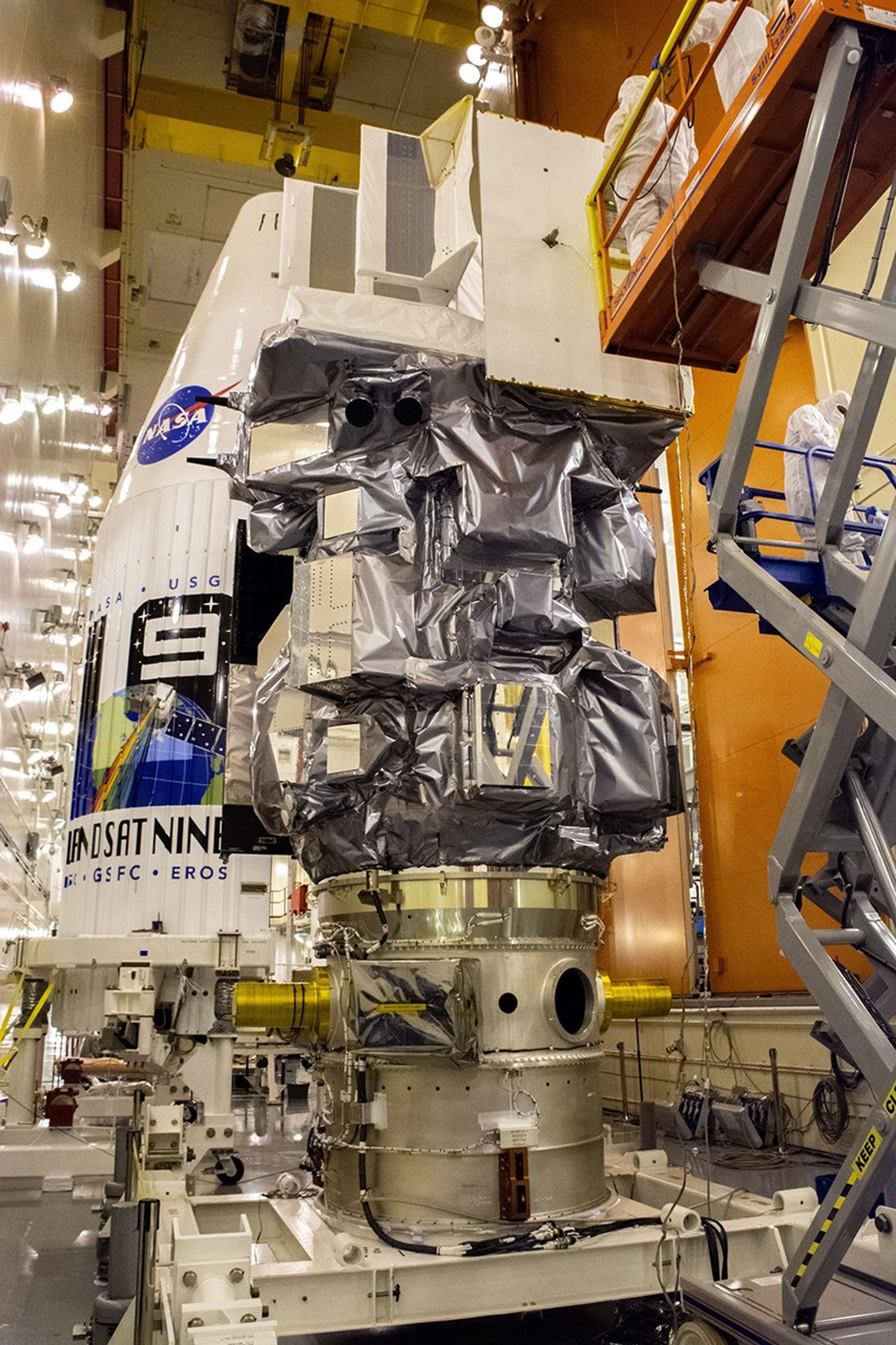 The Landsat 9 instrument cover is removed from the spacecraft inside the Integrated Processing Facility (IPF) at Vandenberg Space Force Base in California.