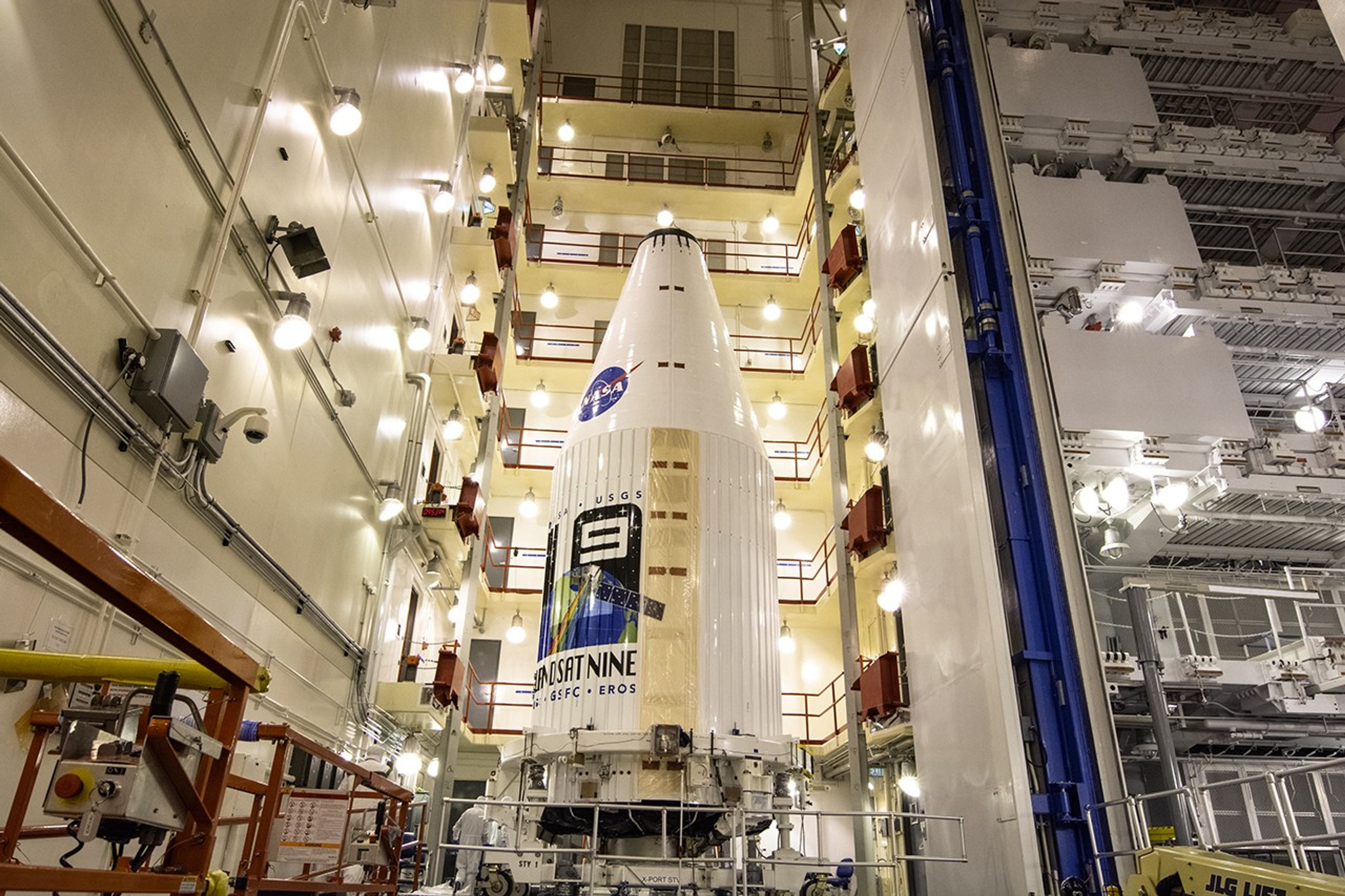 Encapsulated within the United Launch Alliance (ULA) payload fairing, the Landsat 9 spacecraft undergoes final preparations before launch inside the Integrated Processing Facility at Vandenberg Space Force Base in California on Aug. 25, 2021. Landsat 9 will launch on a ULA Atlas V rocket from Space Launch Complex 3 at Vandenberg in September 2021. The launch is being managed by NASA’s Launch Services Program based at Kennedy Space Center, America’s multi-user spaceport. The Landsat 9 satellite will continue the nearly 50-year legacy of previous Landsat missions and monitor key natural and economic resources from orbit. Landsat 9 is managed by the agency’s Goddard Space Flight Center in Greenbelt, Maryland. The satellite will carry two instruments: the Operational Land Imager 2, which collects images of Earth’s landscapes in visible, near infrared and shortwave infrared light, and the Thermal Infrared Sensor 2, which measures the temperature of land surfaces. Like its predecessors, Landsat 9 is a joint mission between NASA and the U.S. Geological Survey.