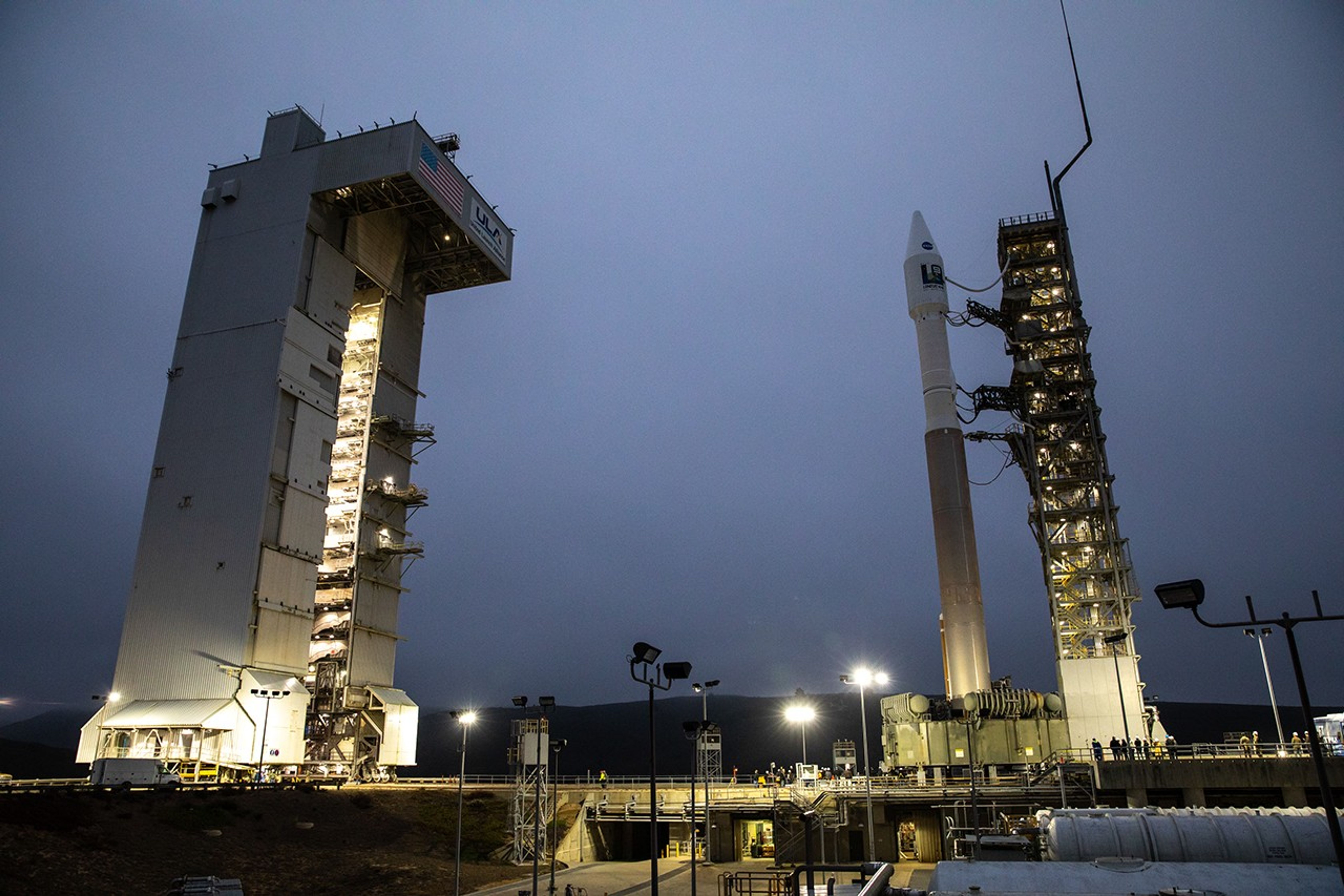 The United Launch Alliance Atlas V 401 rocket with NASA’s Landsat 9 satellite arrives at the launch pad at Space Launch Complex 3 (SLC-3) at Vandenberg Space Force Base in California, on Sept. 27, 2021, after rolling out from the Vertical Integration Facility. Landsat 9 is scheduled to launch at 2:12 p.m. EDT (11:12 a.m. PDT) today, Sept. 27, atop the Atlas V from SLC-3. The launch is managed by NASA’s Launch Services Program based at Kennedy Space Center. The Landsat 9 satellite will continue the nearly 50-year legacy of previous Landsat missions. It will join its sister satellite, Landsat 8, in orbit to monitor key natural and economic resources from orbit. Landsat 9 is managed by the agency’s Goddard Space Flight Center in Greenbelt, Maryland. The satellite will carry two instruments: the Operational Land Imager 2, which collects images of Earth’s landscapes in visible, near infrared and shortwave infrared light, and the Thermal Infrared Sensor 2, which measures the temperature of land surfaces. Like its predecessors, Landsat 9 is a joint mission between NASA and the U.S. Geological Survey.