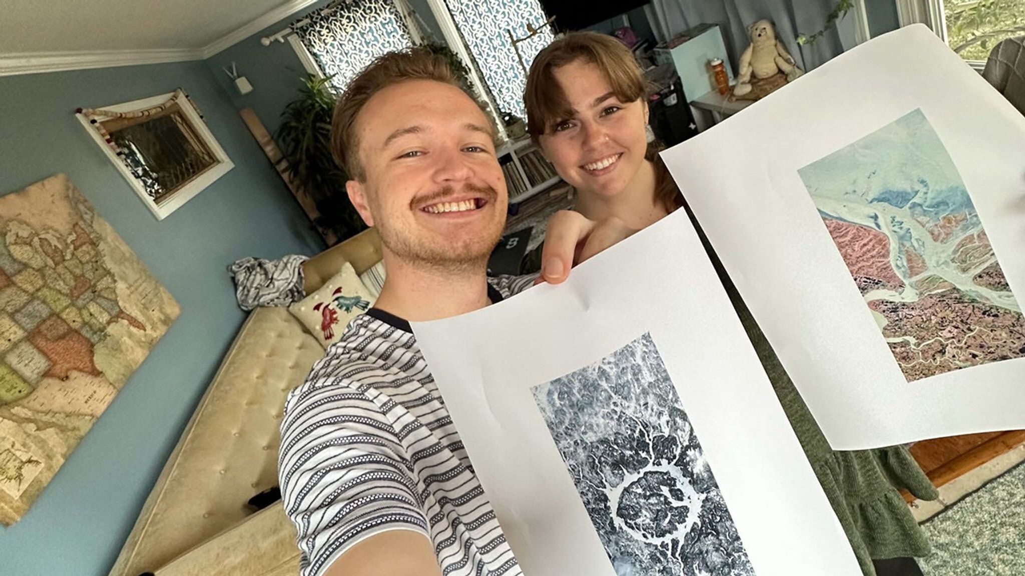 Ross Walter (left) holds a letter O and Ally (right) holds the letter A. Both letters were found in Landsat imagery.