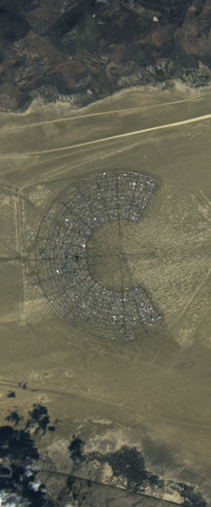 Landsat satellite image of a reflective man-made segmented structure forms the lower case letter C in the middle of the Black Rock Desert.