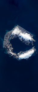 Landsat satellite image of a mountainous island forming the lower case letter C. The island is covered by snow and ice on the upper and lower right portions.