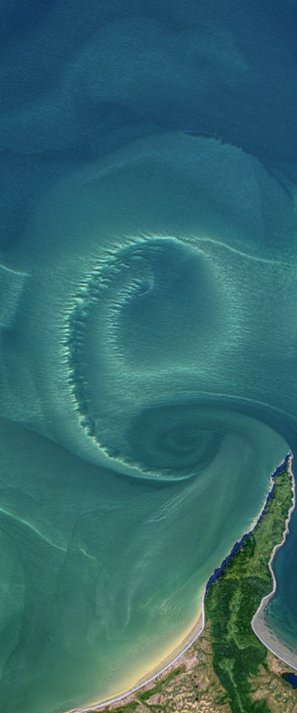 Landsat satellite image of ocean turbulence forming the lower case letter E.