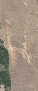 Landsat satellite image of a dry mountainous region with two layers or colors forms the upper case letter H.