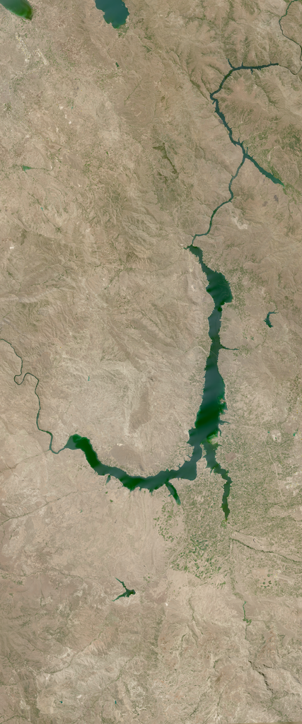 Water feature forms the lower case letter J in this Landsat satellite image.