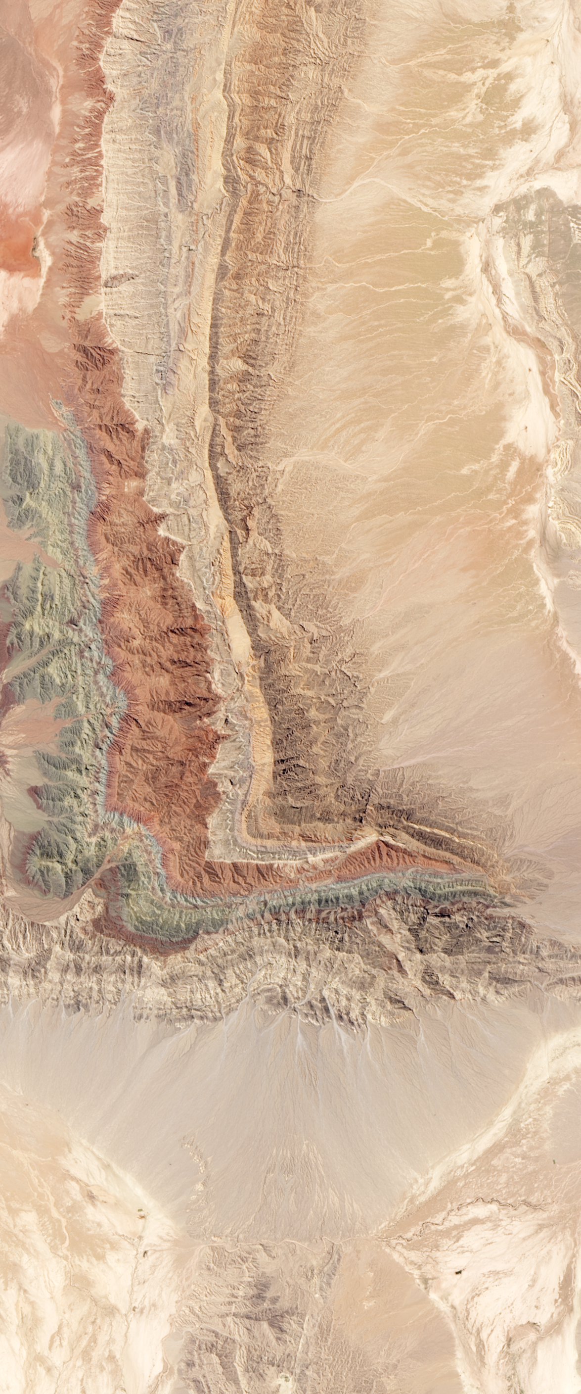 Landsat satellite image of sedimentary rock layer ridges forming the capital letter L.