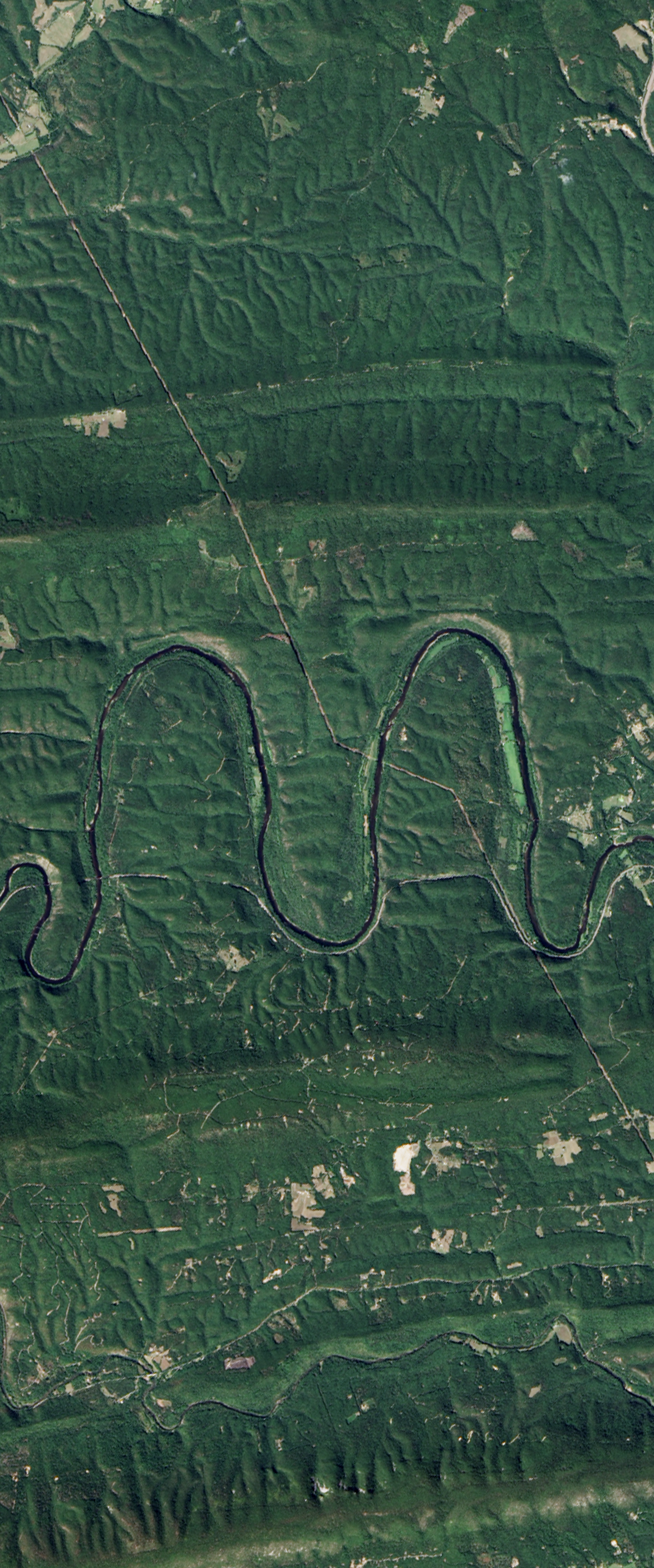 Landsat satellite image showing a curvy river forming the lower case letter M.