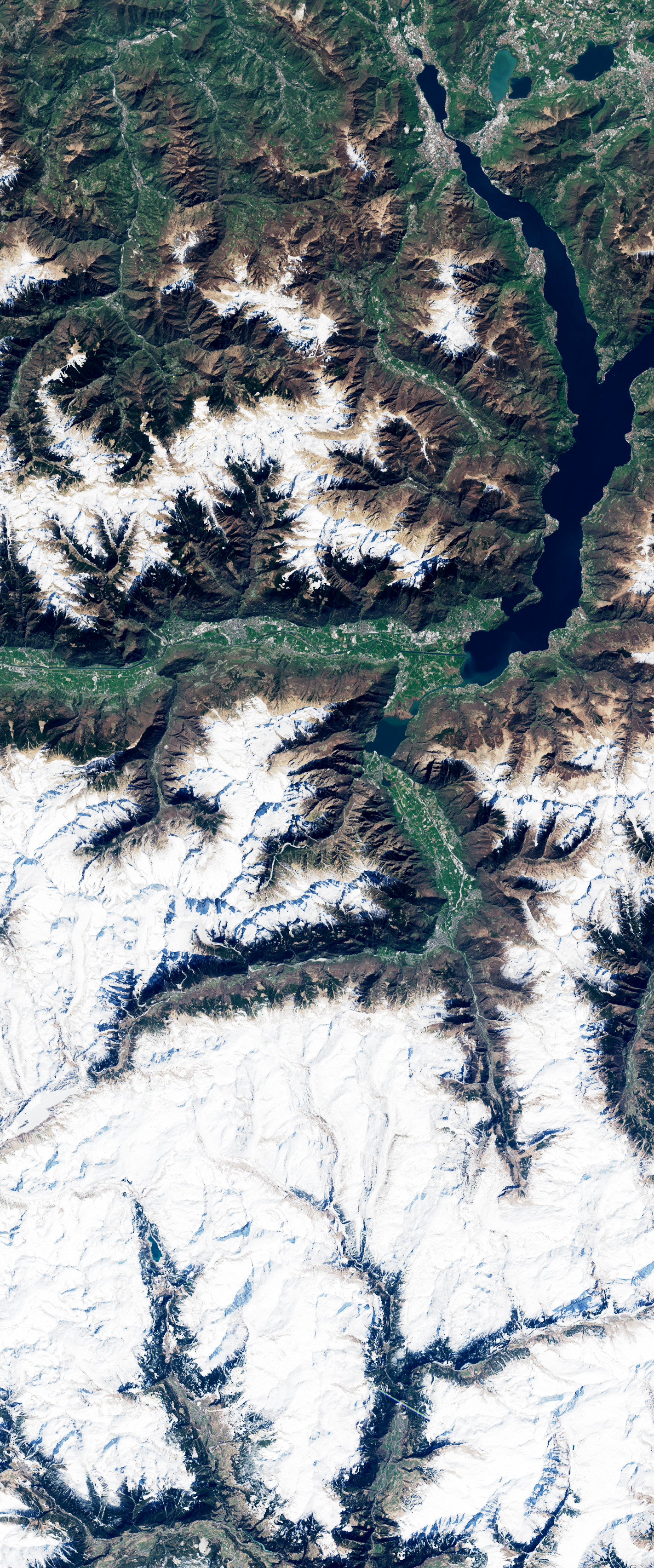 Landsat satellite image showing bare land among forested slopes forming the number 3.