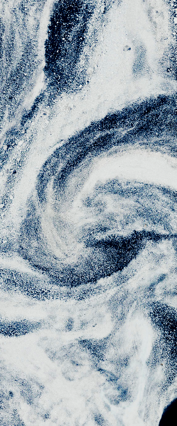 Landsat satellite image of swirling white sea ice and dark ocean water forms the uppercase letter g.