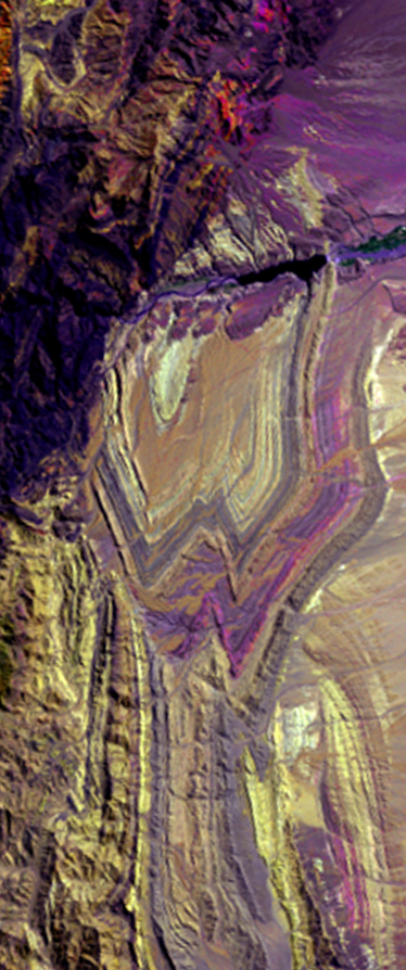 Landsat satellite image of mountainous ridges in false-color forming the capital letter W.