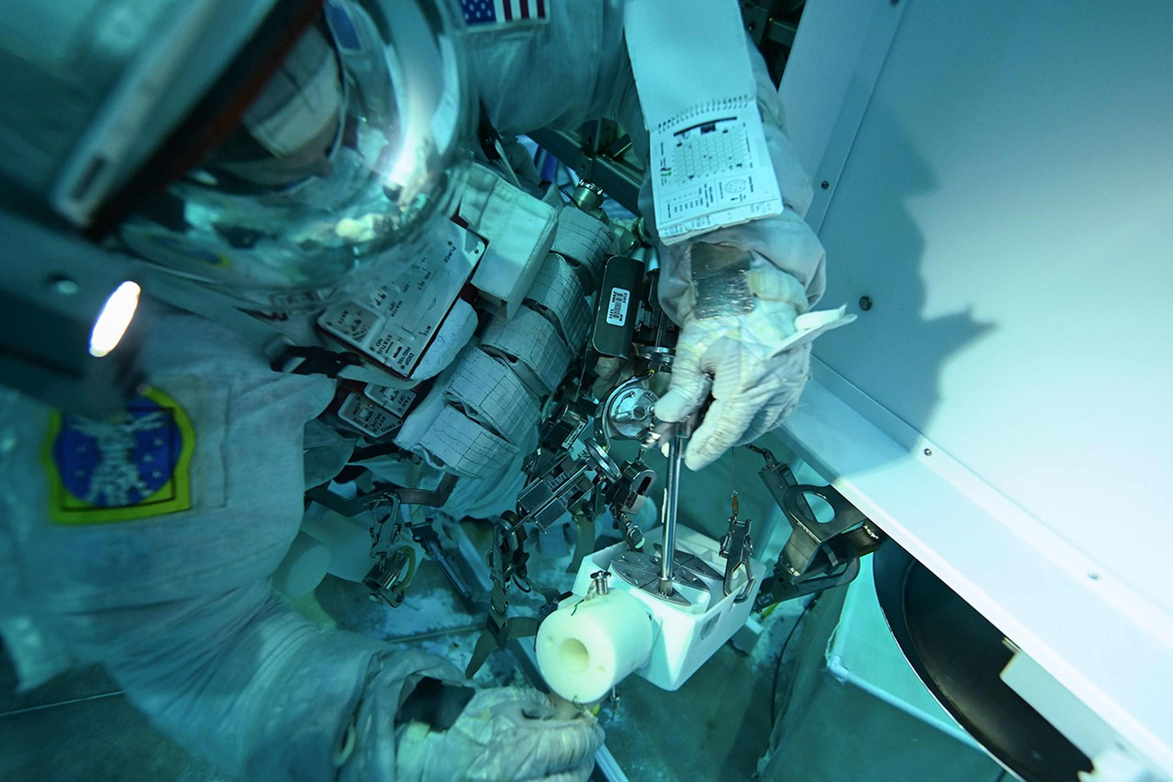 An astronaut practicing in a pool