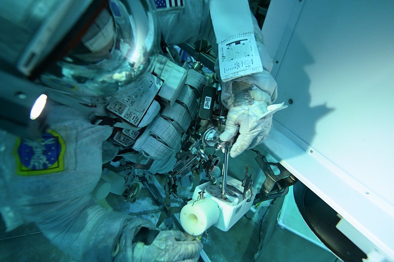 An astronaut practicing in a pool