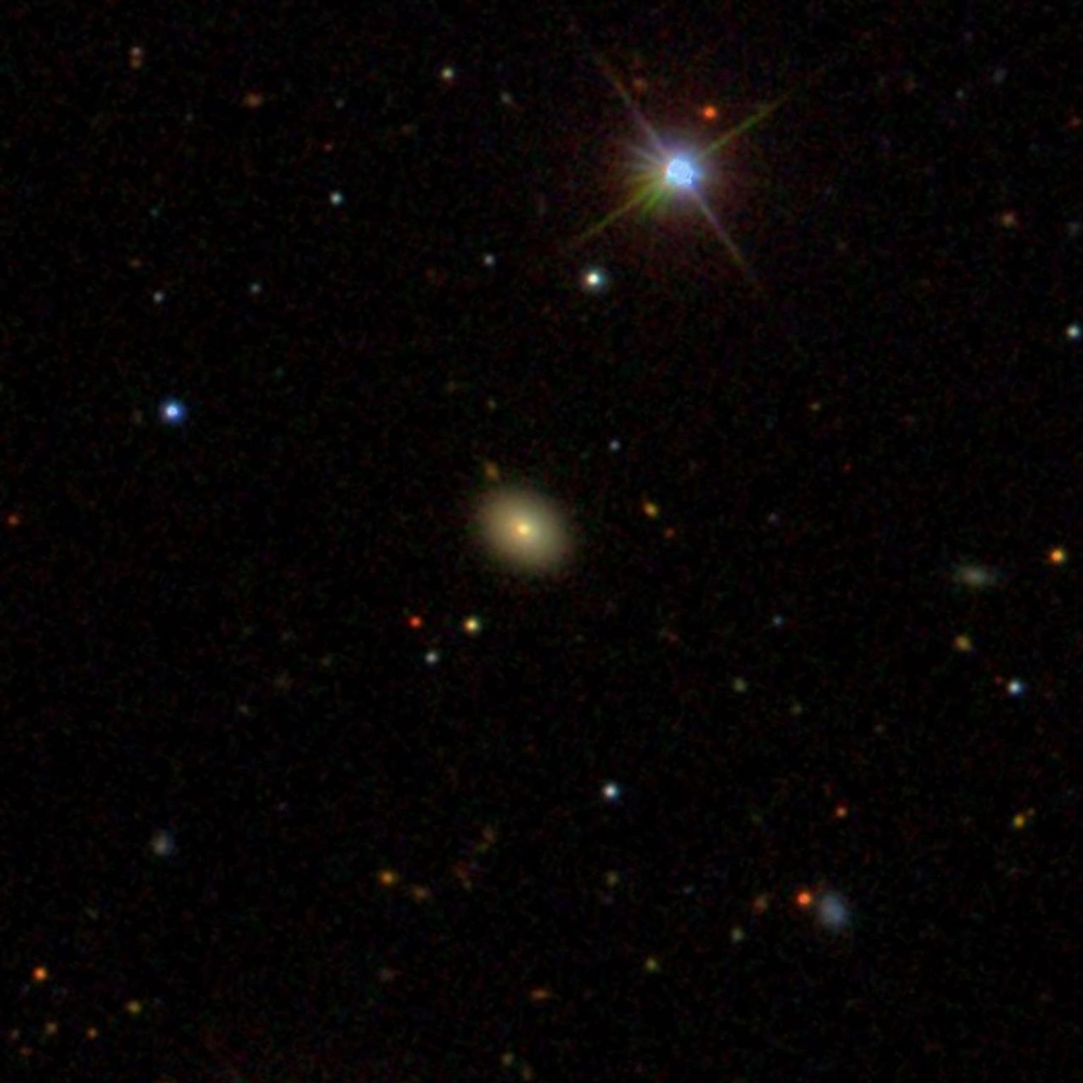 A red circle encompasses a galaxy in a snapshot of an all-sky survey.