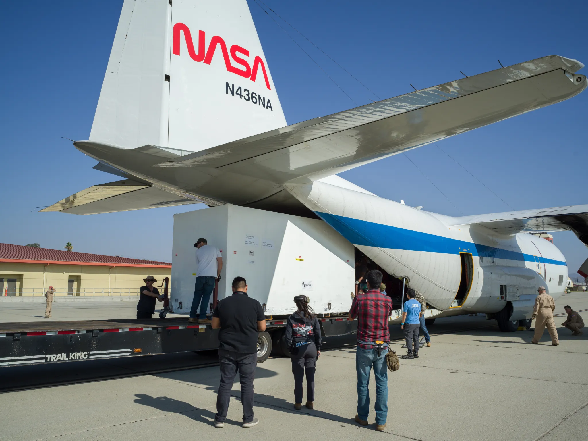 A container holding NISAR’s radar antenna reflector is loaded into NASA’s C-130 cargo plane at March Air Reserve Base in Riverside County, California, on Oct. 15. The aircraft transported the reflector to Bengaluru, India, arriving at ISRO’s satellite integration and test facility on Oct. 22. NASA/JPL-Caltech