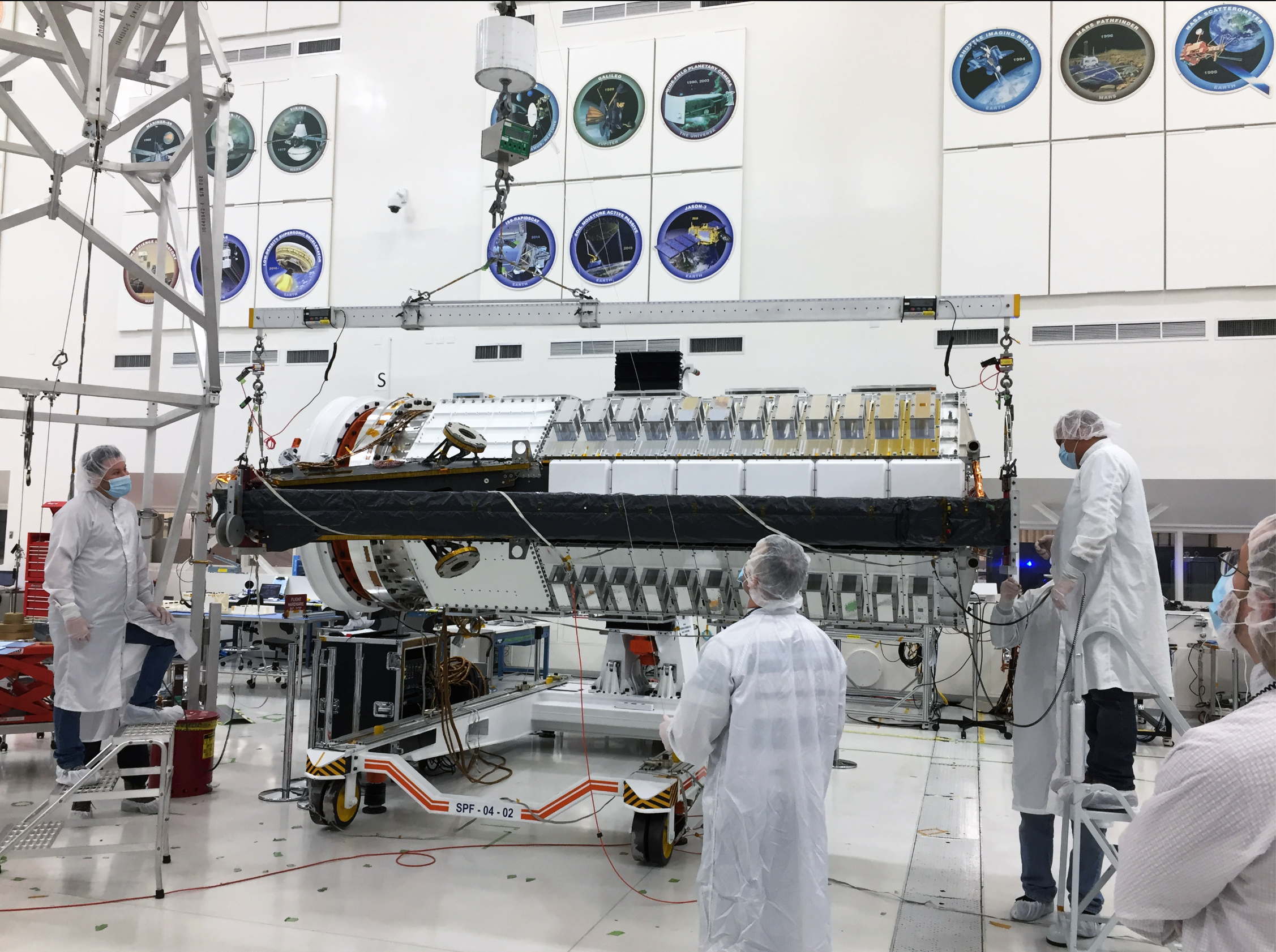 Engineers assemble NISAR's lower antenna boom in the clean room at NASA's Jet Propulsion Laboratory