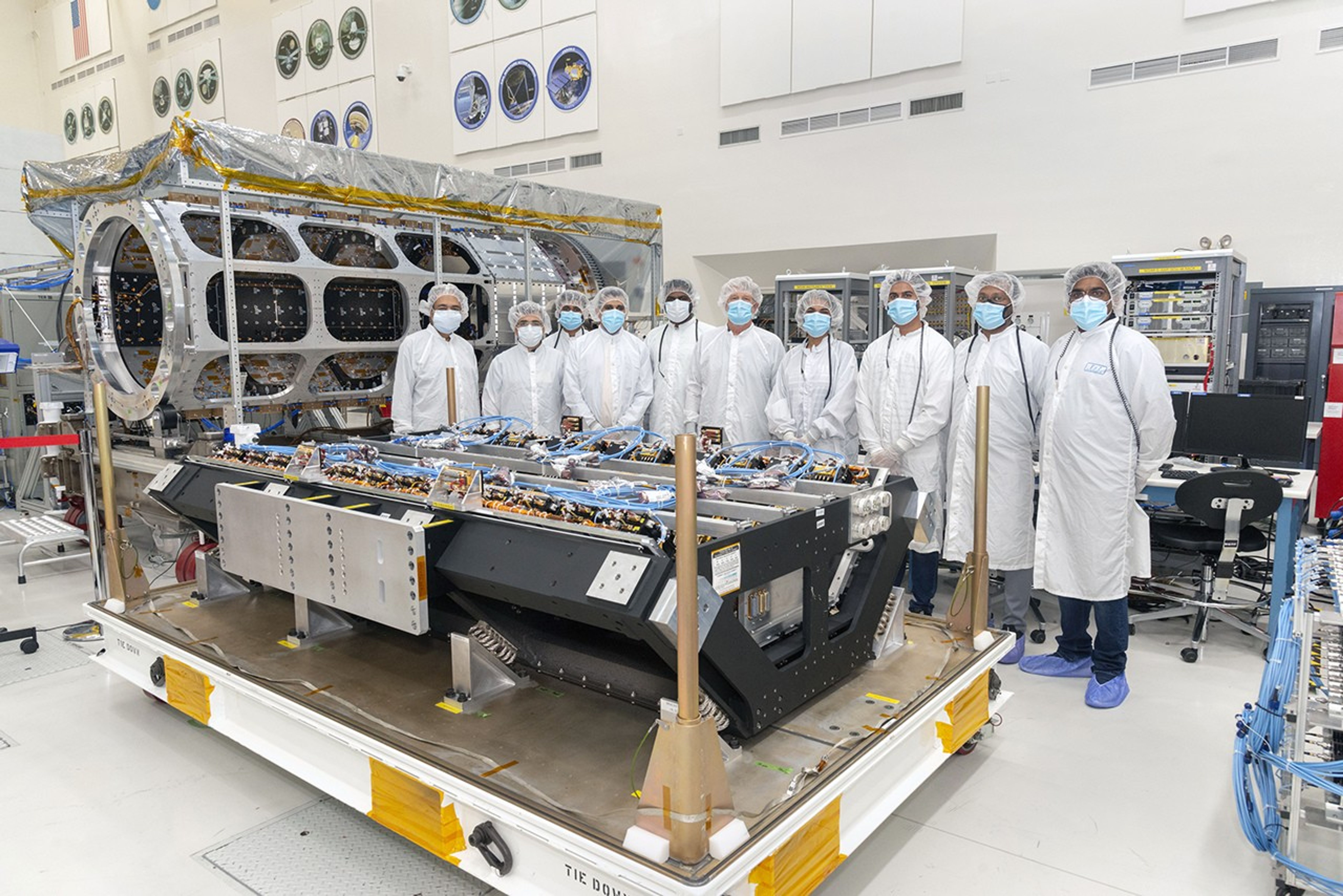 Members of the integration and test team from NASA’s Jet Propulsion Laboratory and the Indian Space Research Organization (ISRO) pose with NISAR’s S-synthetic aperture radar (S-SAR) instrument in the clean room at NASA's Jet Propulsion Laboratory
