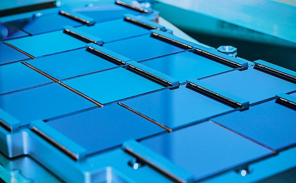 A close-up view of deep-blue, partly reflective gridded squares.