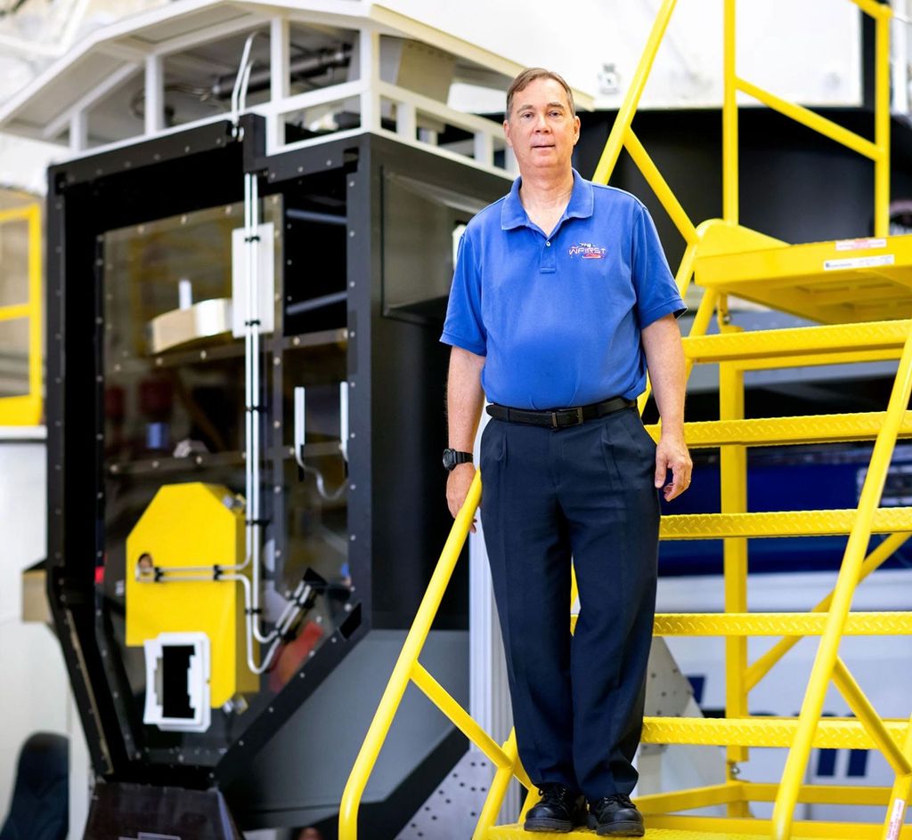 A man standing on a ladder.
