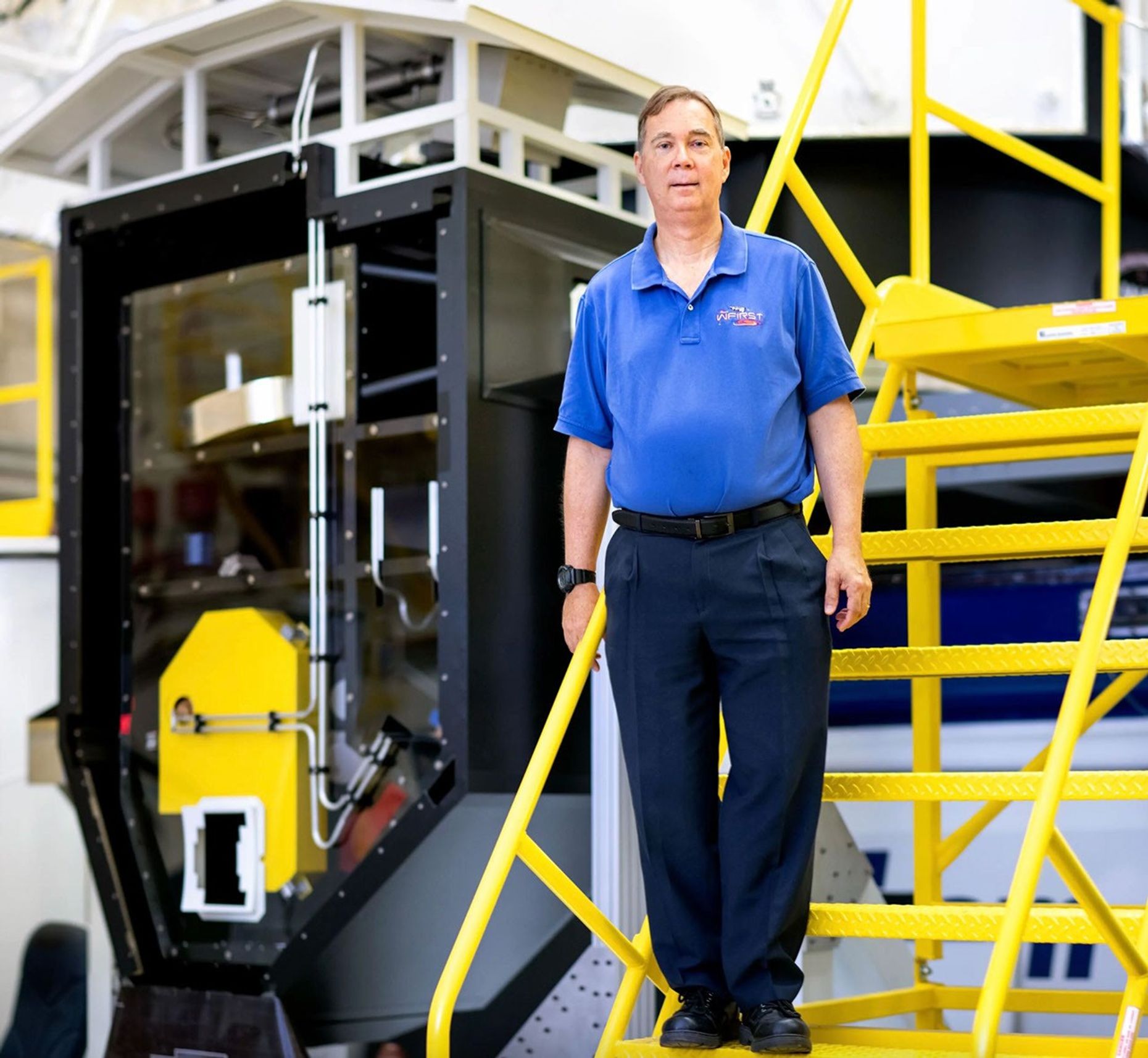 A man standing on a ladder.