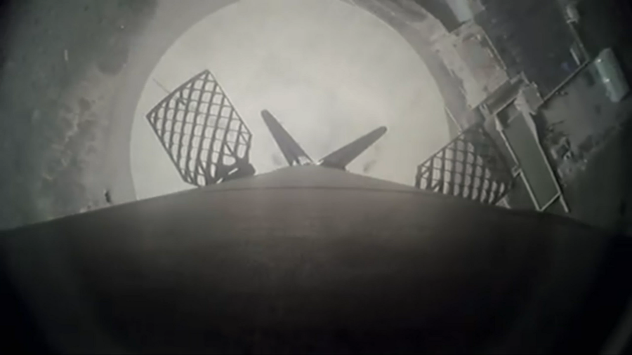 Looking down, an image shows a SpaceX first stage booster returning to Landing Zone 4 East at Vandenberg Space Force Base in California following launch of Sentinel-6B.