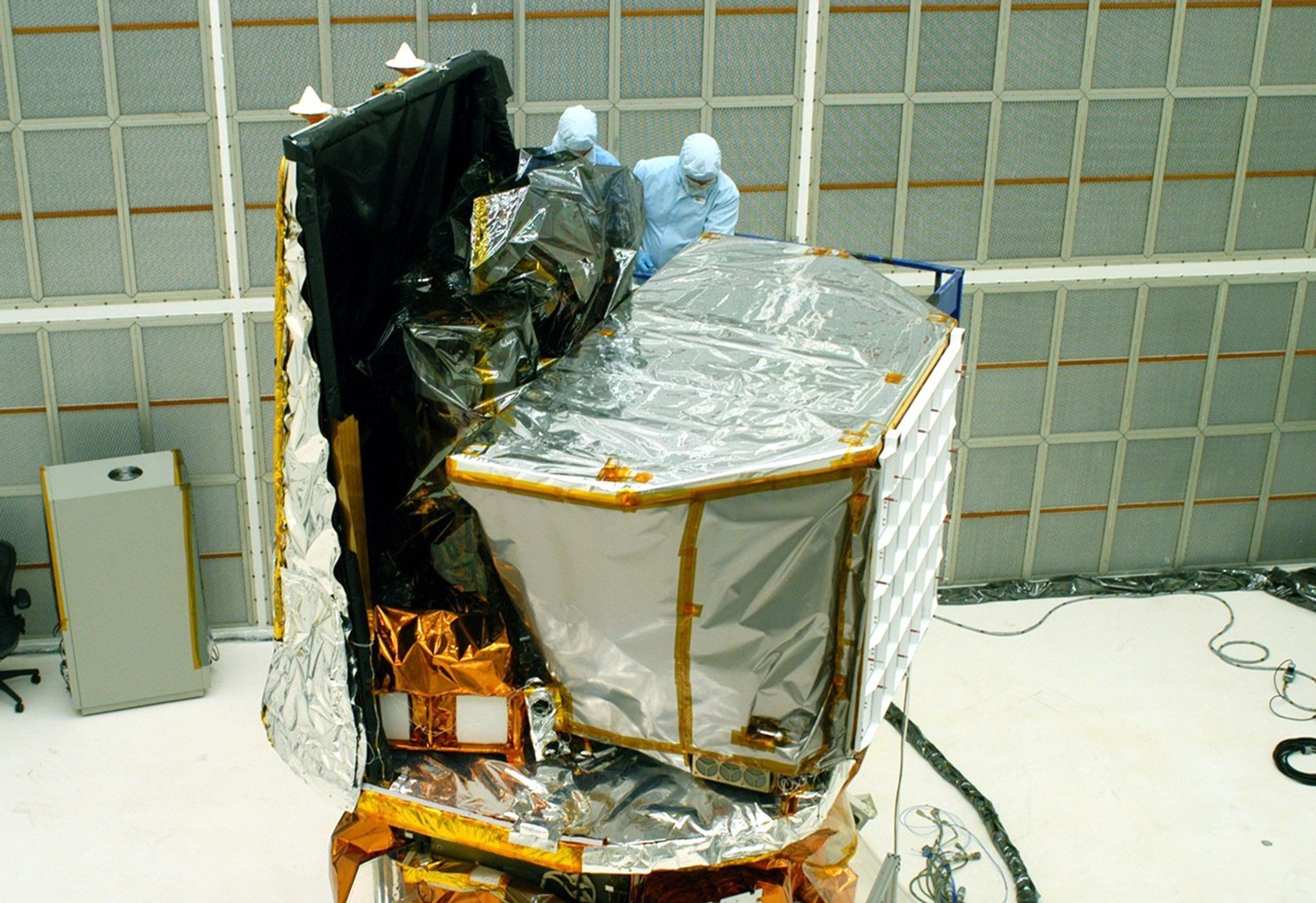 Photo of technicians working on the Swift spacecraft.