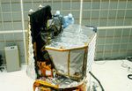 Photo of technicians working on the Swift spacecraft.