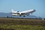 An airplane with a rocket attached to the bottom takes off