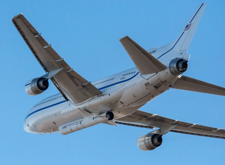 An airplane with a rocket attached to the bottom