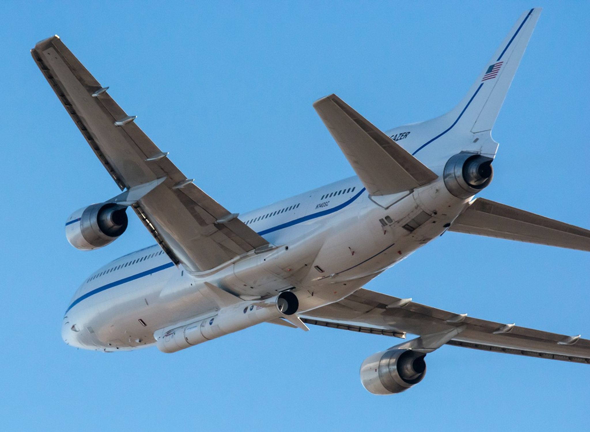 An airplane with a rocket attached to the bottom