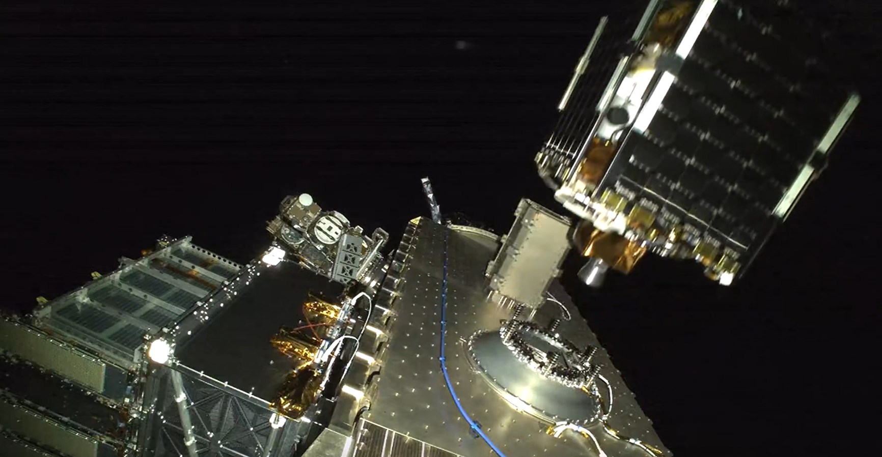 Image shows a silver satellite releasing from a silver payload in orbit