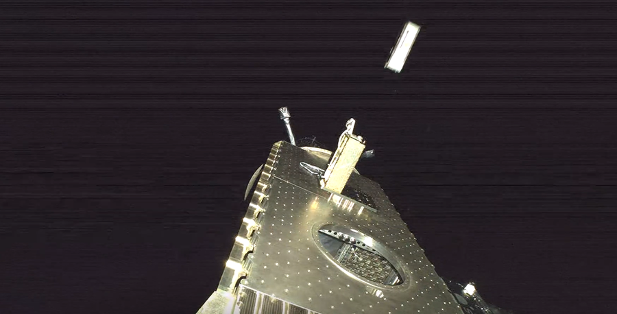 Image shows a silver metallic CubeSat releasing from a silver payload in orbit.