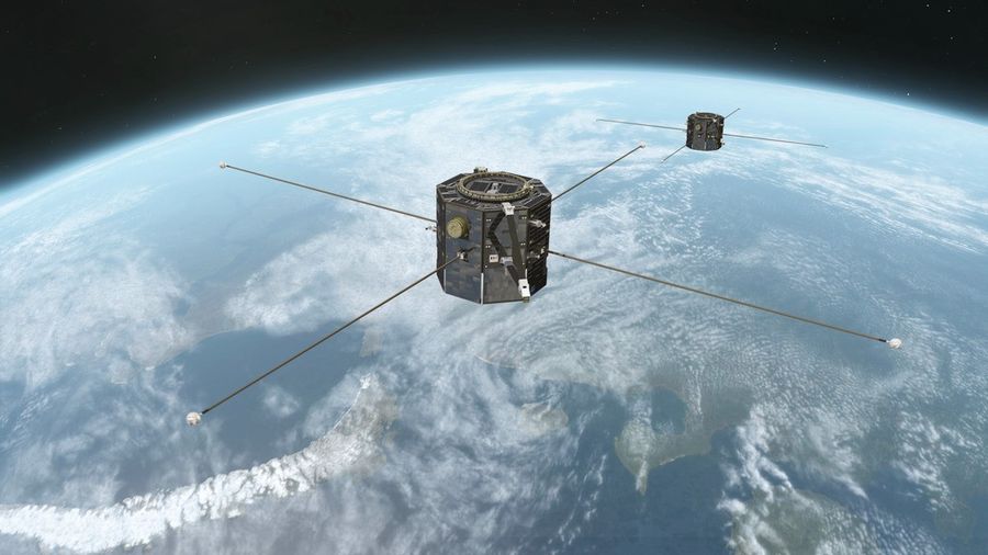 An artist's concept showing TRACERS above Earth. TRACERS is twin satellites, both gray and octagonal, with four poles sticking outward horizontally.