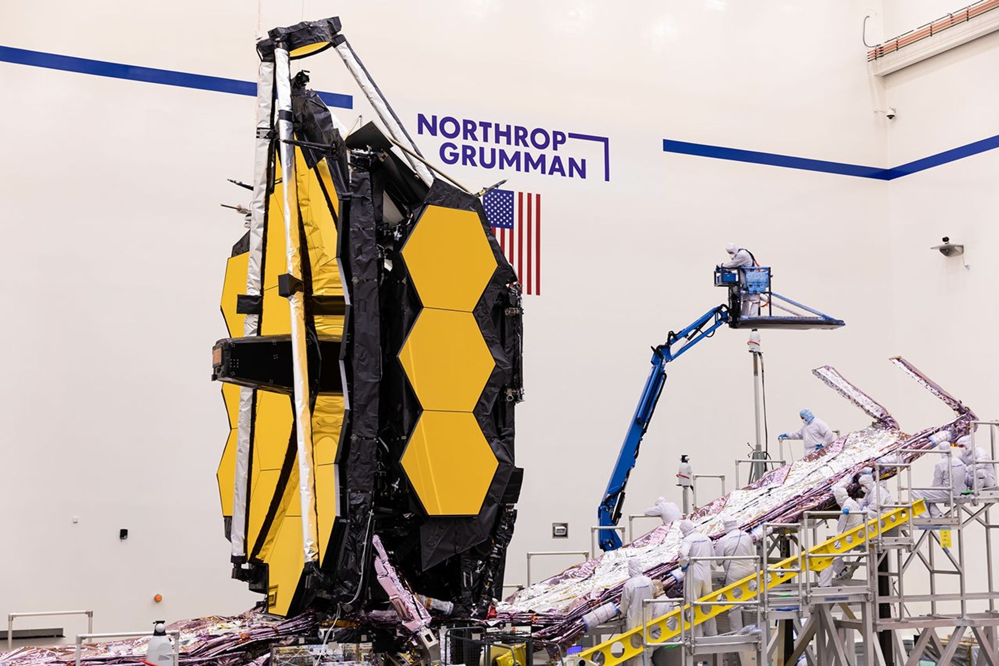 This archival image is from May 2021 when Webb was at the Northrop Grumman facility. During this approximate time period (late spring to early summer), the telescope was having its sunshield packed up and prepped for launch, and the final test fold of the mirror wings was also taking place.
