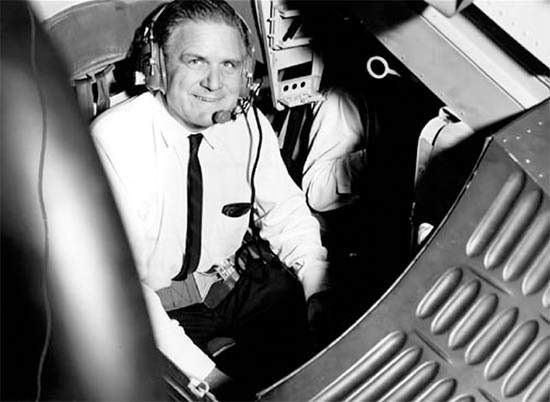 Black-and-white photograph of James Webb looking at the camera and smiling.