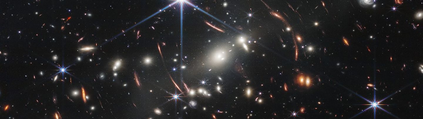 Thousands of distant galaxies of different shapes, sizes, colors, and brightness, with a scattering of bright foreground stars.