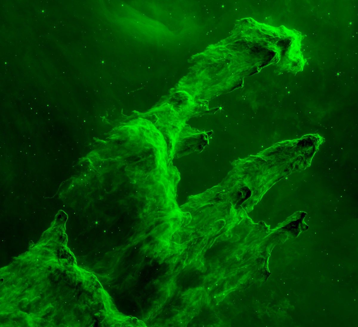 The Pillars of Creation are shown in a green. The edges of the finger-like pillars are bright green, and some stars appear in the background.