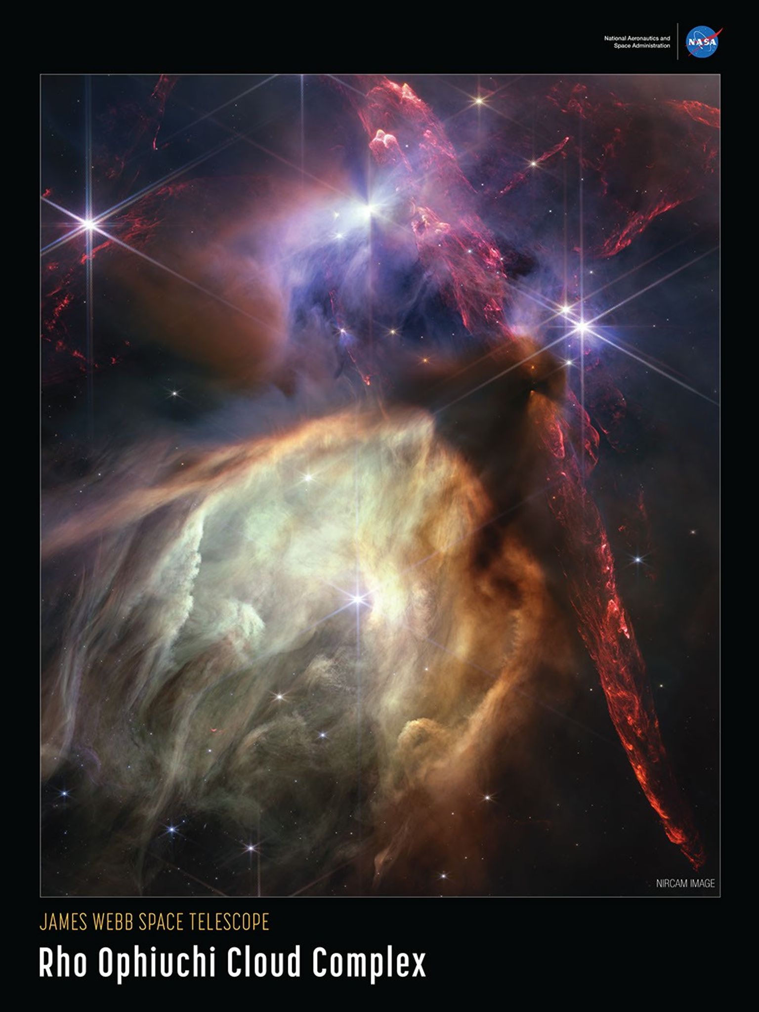 Near-infrared image of Rho Opiuchi outlined in white, set on a black background. Red dual opposing jets coming from young stars fill the darker top half of the image, while a glowing pale-yellow, cave-like structure is bottom center, tilted toward two o'clock, with a bright star at its center. At the top right of the poster is the blue, red, and white NASA logo, with the words "National Aeronautics and Space Administration", in white text to its left. The words "NIRCam Image" are set in a small white type on the bottom right of the image. The title is set below the image, along the bottom of the poster: "James Webb Space Telescope" appears in small orange type on the top line with "Rho Ophiuchi Cloud Complex" in large white type on the bottom line.