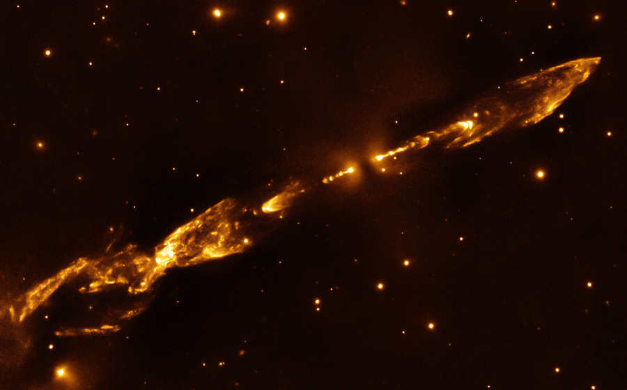 A pair of thin horizontal orange-gold jets are tilted from bottom left to top right, known as Herbig-Haro 212.